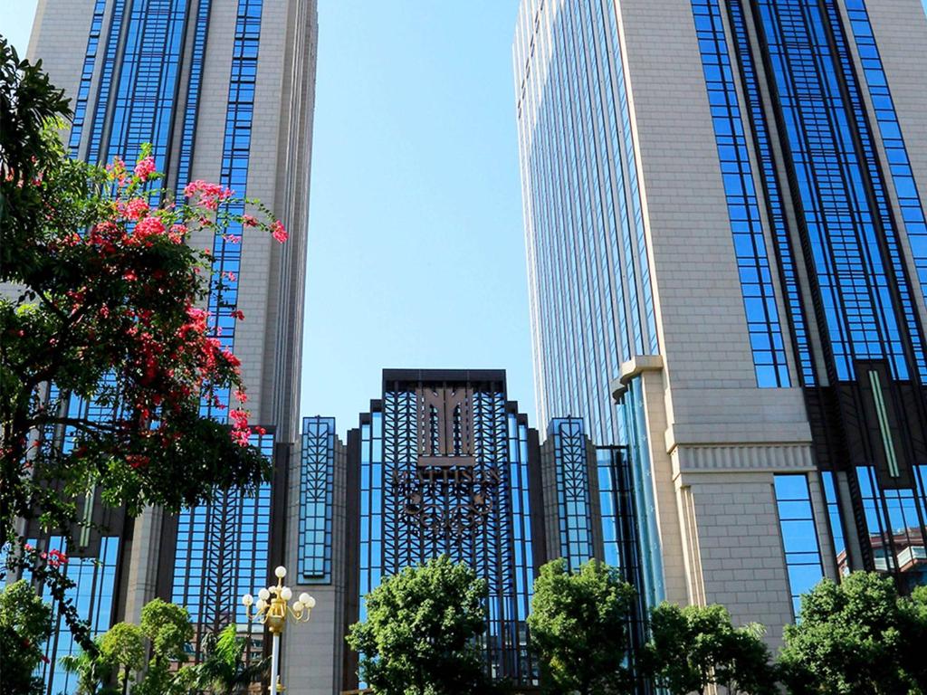 a group of tall buildings in a city at Pullman Shishi Mattison in Shishi