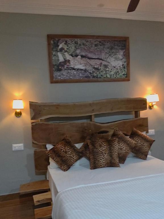 a bedroom with a white bed with brown pillows at Centre point jawai in Bīsalpur
