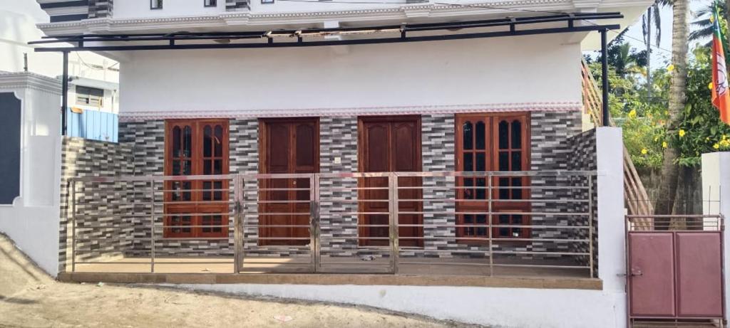 a building with a bunch of windows on it at punartham homestay in Kovalam