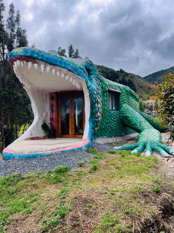 a house shaped like a dinosaur with a mouth at La Boca del Lagarto Lodge in Cucunubá