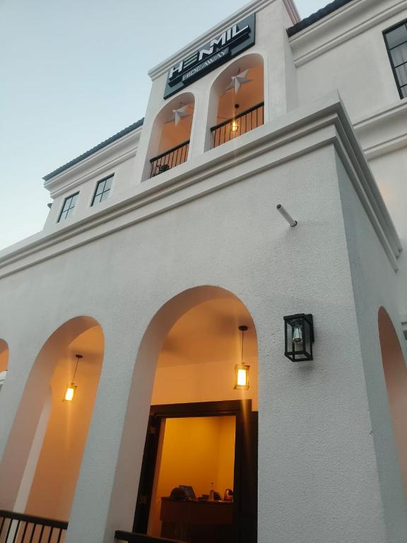 a white building with windows and a sign on it at Henmil Hideaway in Anjuna