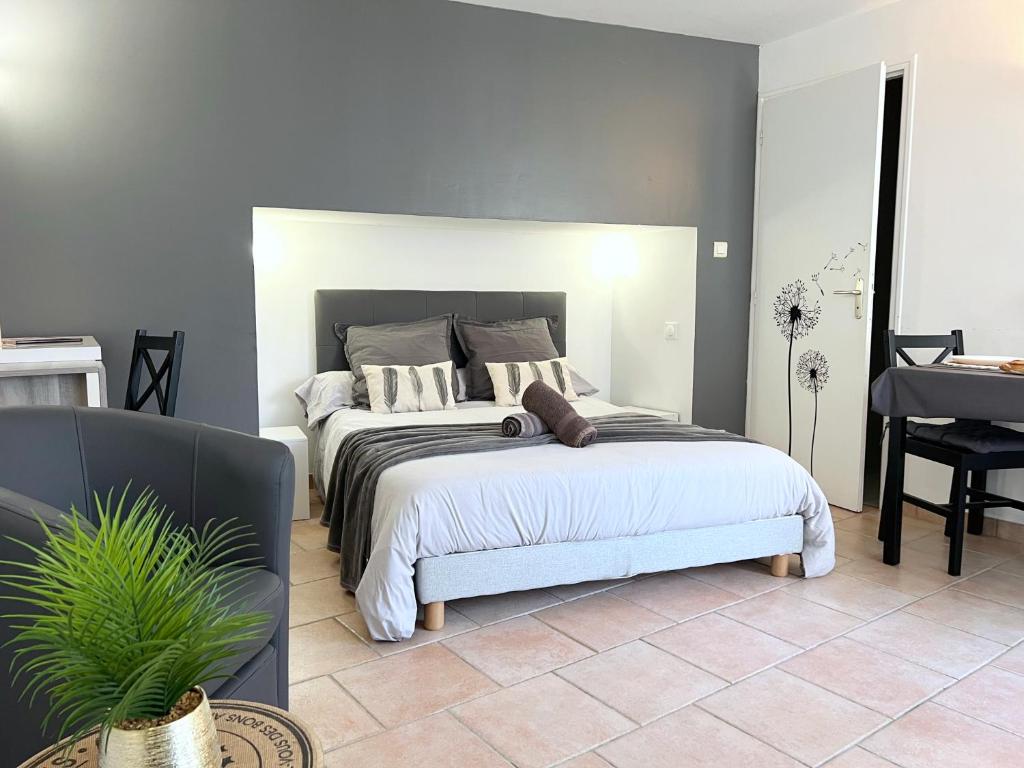 a bedroom with a large bed and a piano at Le Petit Cocon - Lumineux & Confortable in Cerizay
