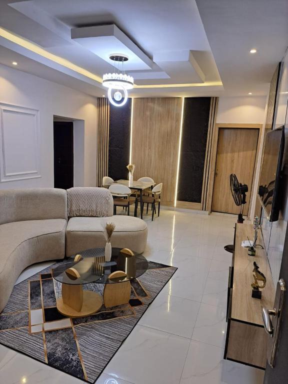 a living room with a couch and a table at Diolux Serviced Apartments in Lekki
