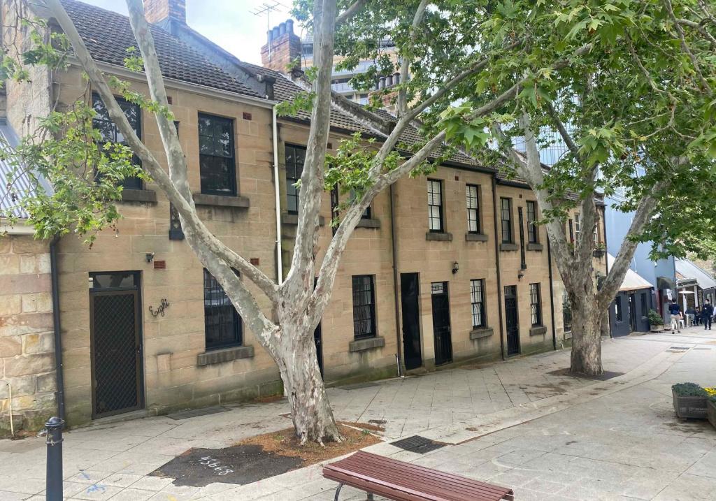 a building with a bench in front of it at 2 Bedroom Pyrmont Terrace House in Sydney