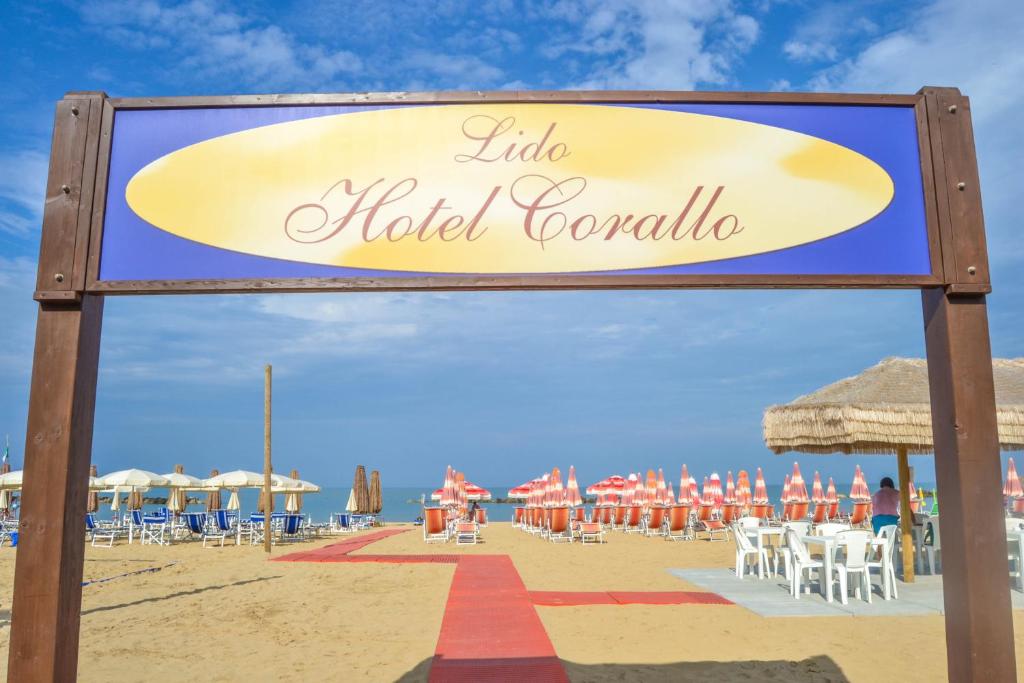a sign for a hotel on the beach at Hotel Corallo in Francavilla al Mare