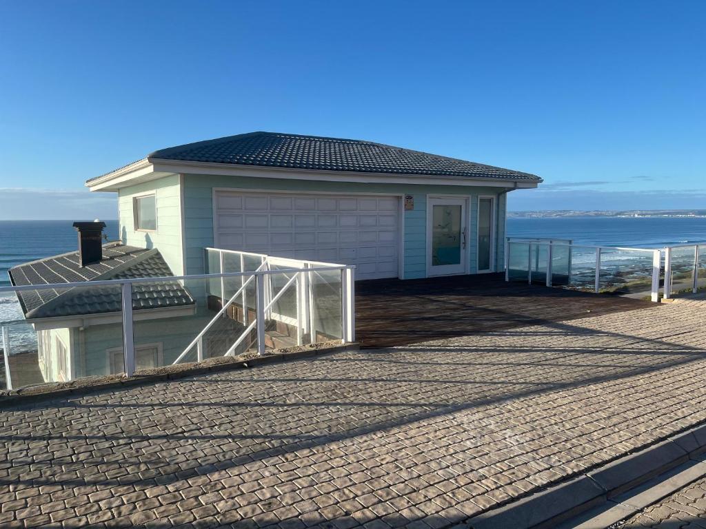 a house on the beach with the ocean behind it at 8 Muller st Tergniet in Tergniet
