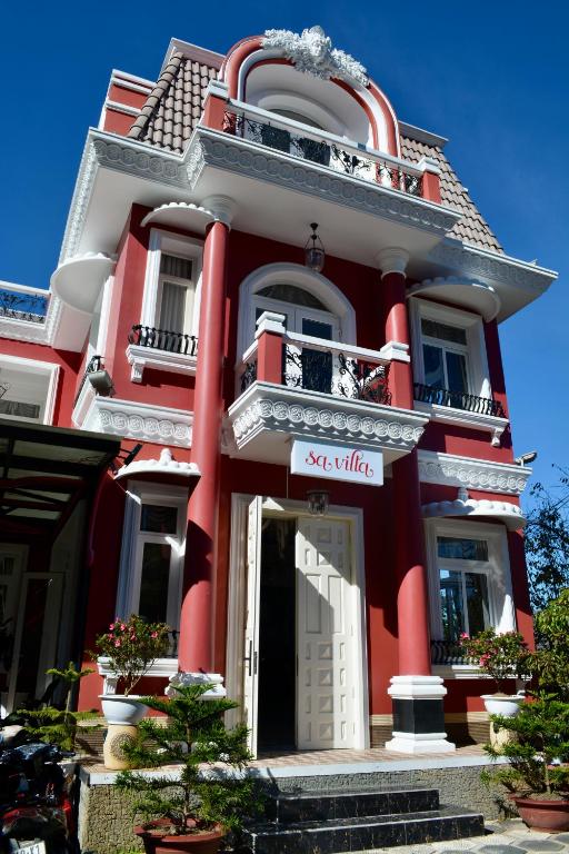 a red building with a sign in front of it at Sa Villa Da Lat in Da Lat