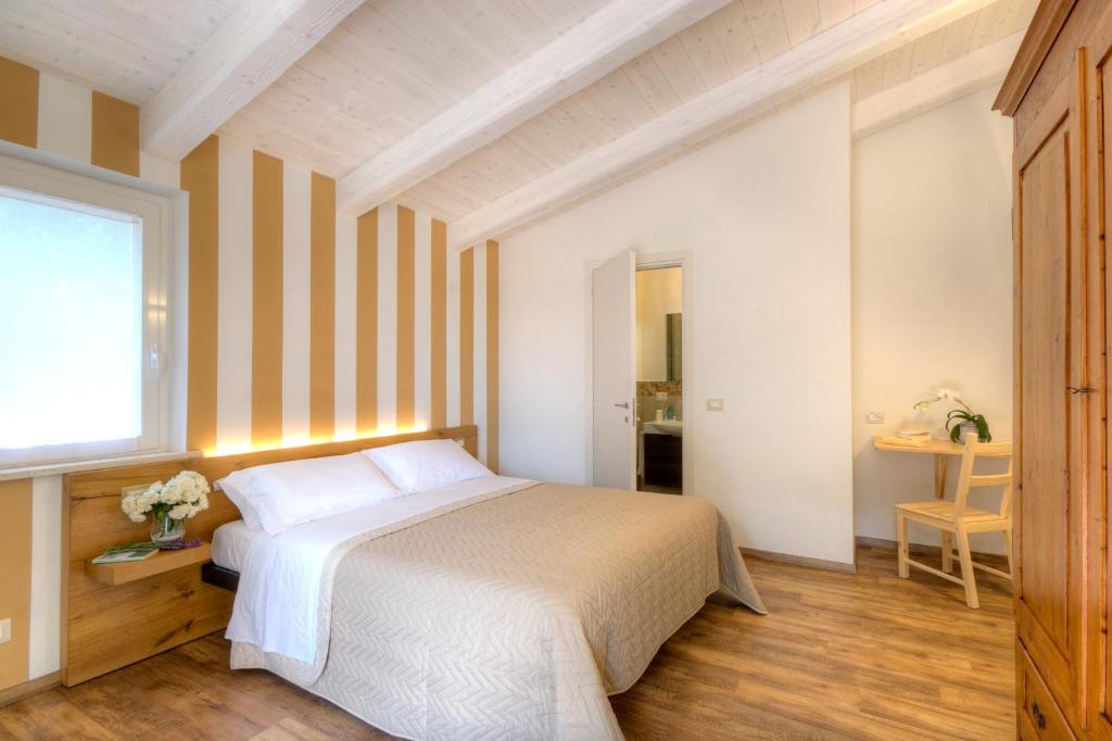 a bedroom with a white bed and a window at Bellafiora Affittacamere in Osimo