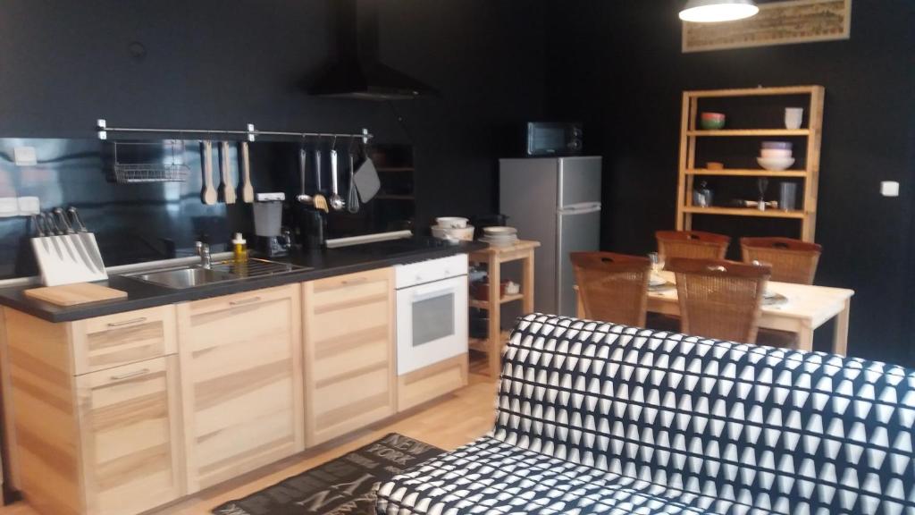 a kitchen with a sink and a counter top at Apt 5 du Temple HyperCentre & Parking in Cambrai