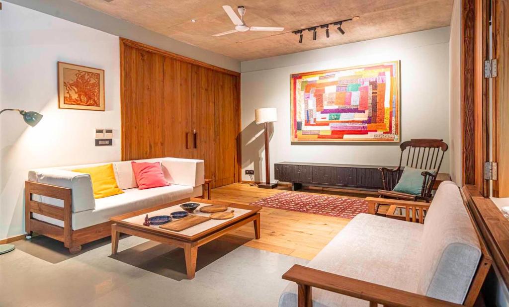 a living room with a couch and a table at Gulmohar527 3BHK Service Apartment Defence Colony in Jāmb