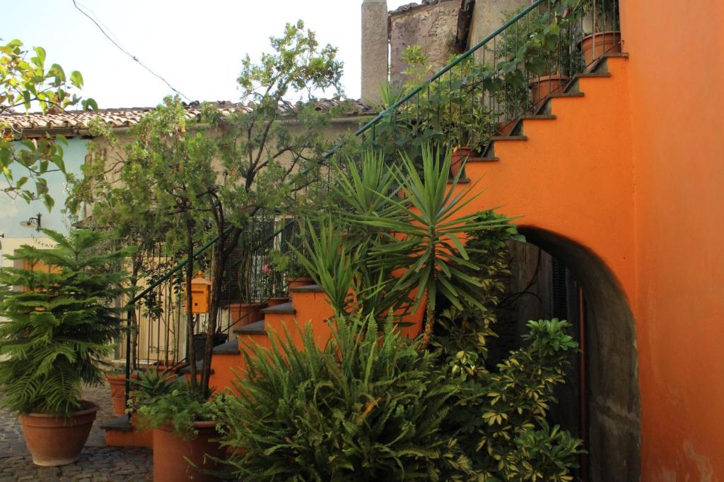 an orange building with plants on the side of it at La Scaletta in Formello