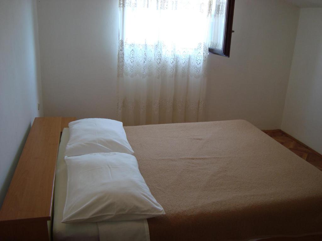 Postel nebo postele na pokoji v ubytování Apartmani Ždrelac