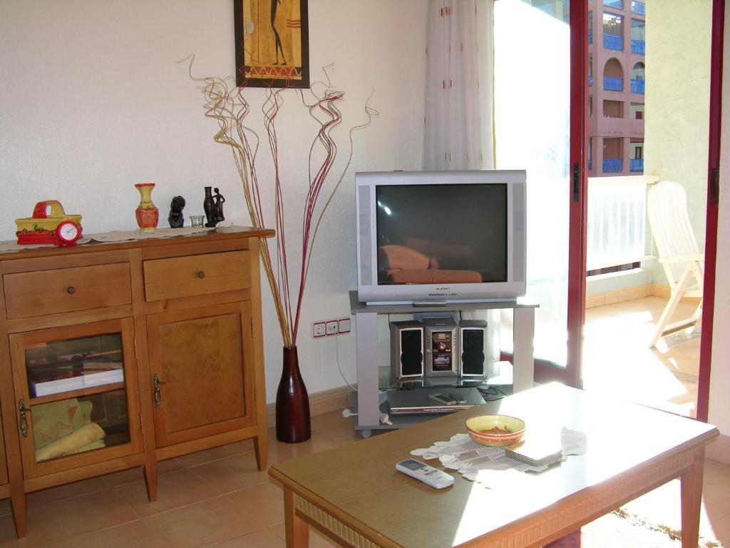 A television and/or entertainment centre at Verdemar 8907 - Resort Choice