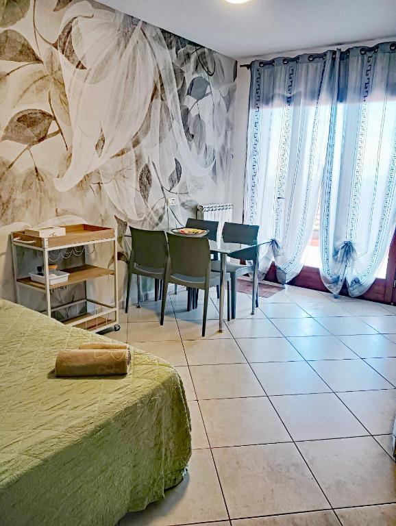 a bedroom with a table and a table and chairs at Monolocale Tre Mari in Capoliveri