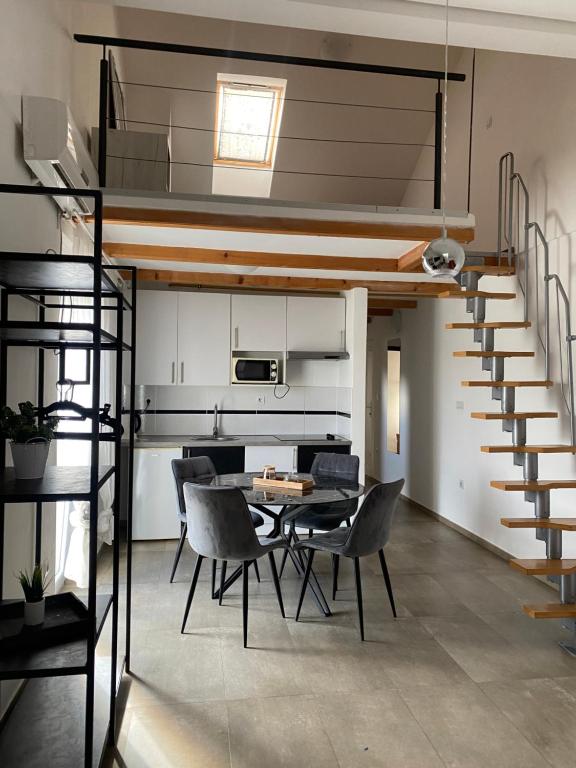 a living room with a loft bed and a table and chairs at Apartman Lapaž 12 in Toplice Sveti Martin