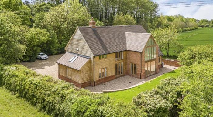 an aerial view of a house with a car parked at Glebe Barn in Cuxham