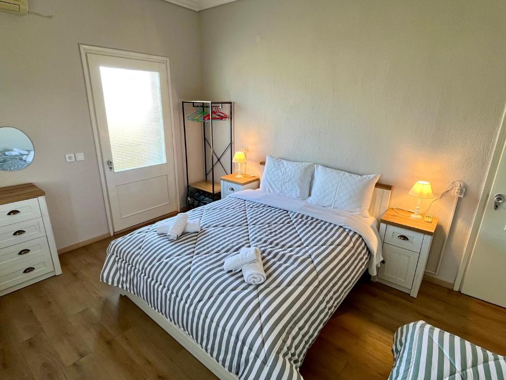 a bedroom with a bed with two stuffed animals on it at Mary's Villa in Xanthi