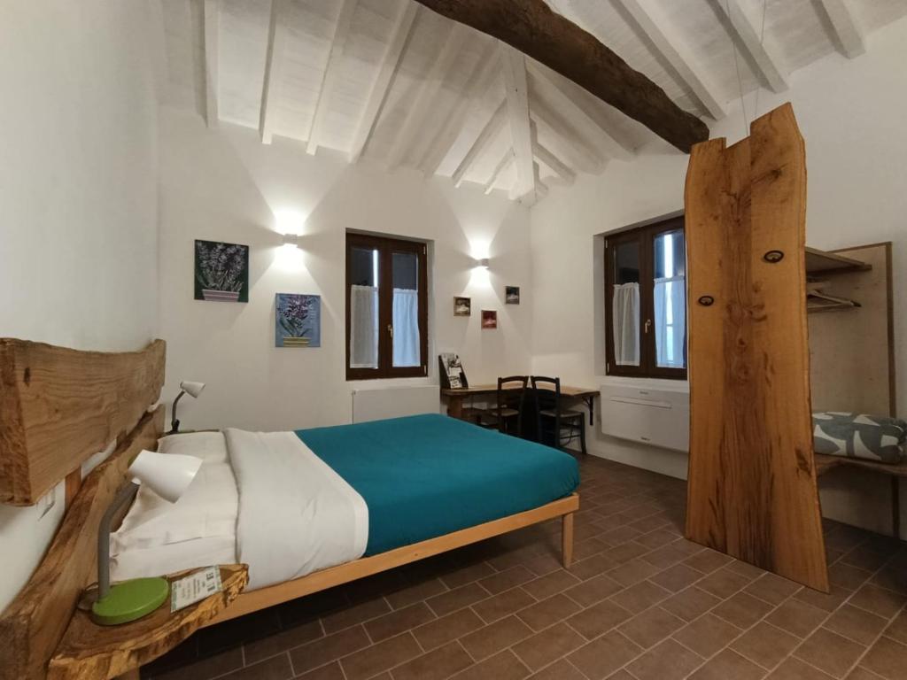 a bedroom with a bed in a room with a table at Agriturismo Parco della Chiusa in Casalecchio di Reno