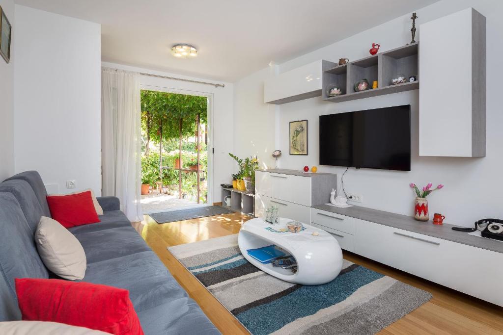 a living room with a couch and a tv at Apartment Mirjana in Split