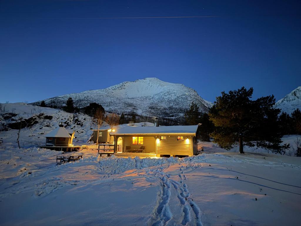 a log cabin in the snow at night at Nittebu in Buvika