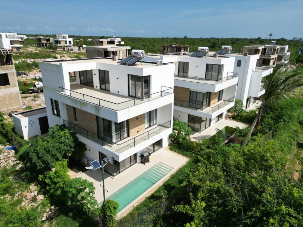 an aerial view of a white house with a swimming pool at Bustani Villa in Mchamba Wima