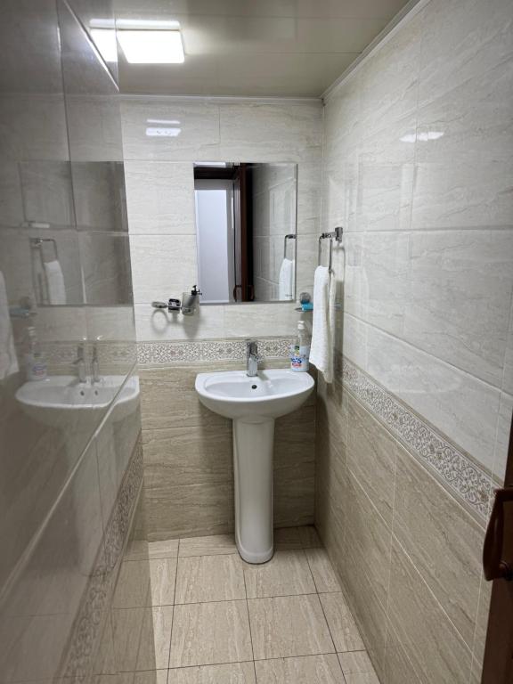 a bathroom with a sink and a mirror at Chorsu Old City in Tashkent