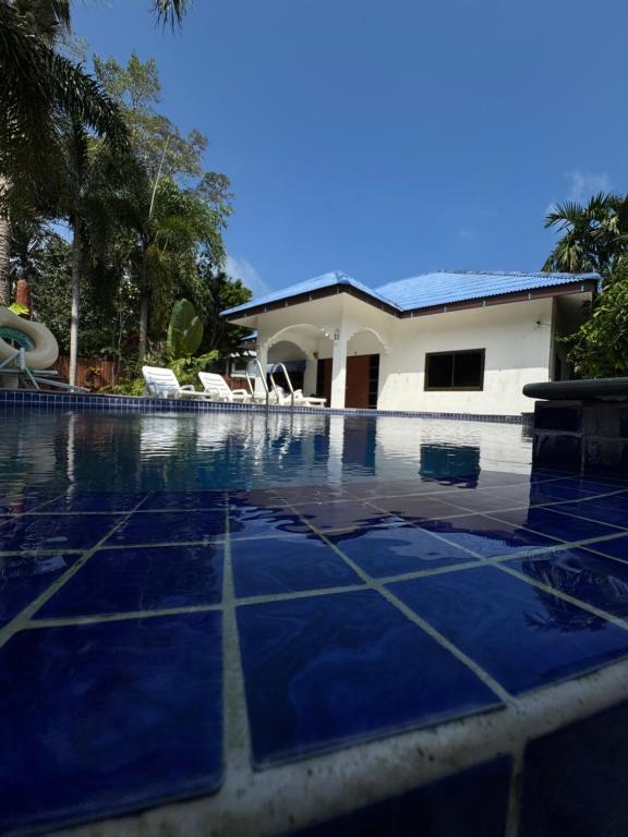 a swimming pool in front of a house at SU house Koh Phangan in Thong Nai Pan Yai