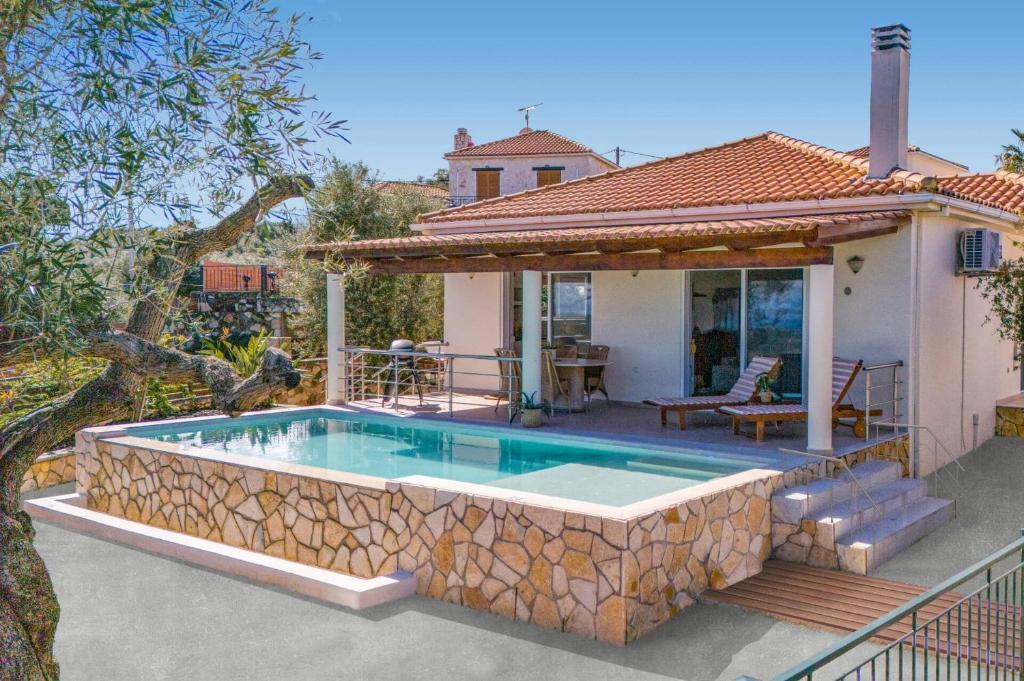a swimming pool in front of a house at Villa Gisele with Private Pool in Tragaki
