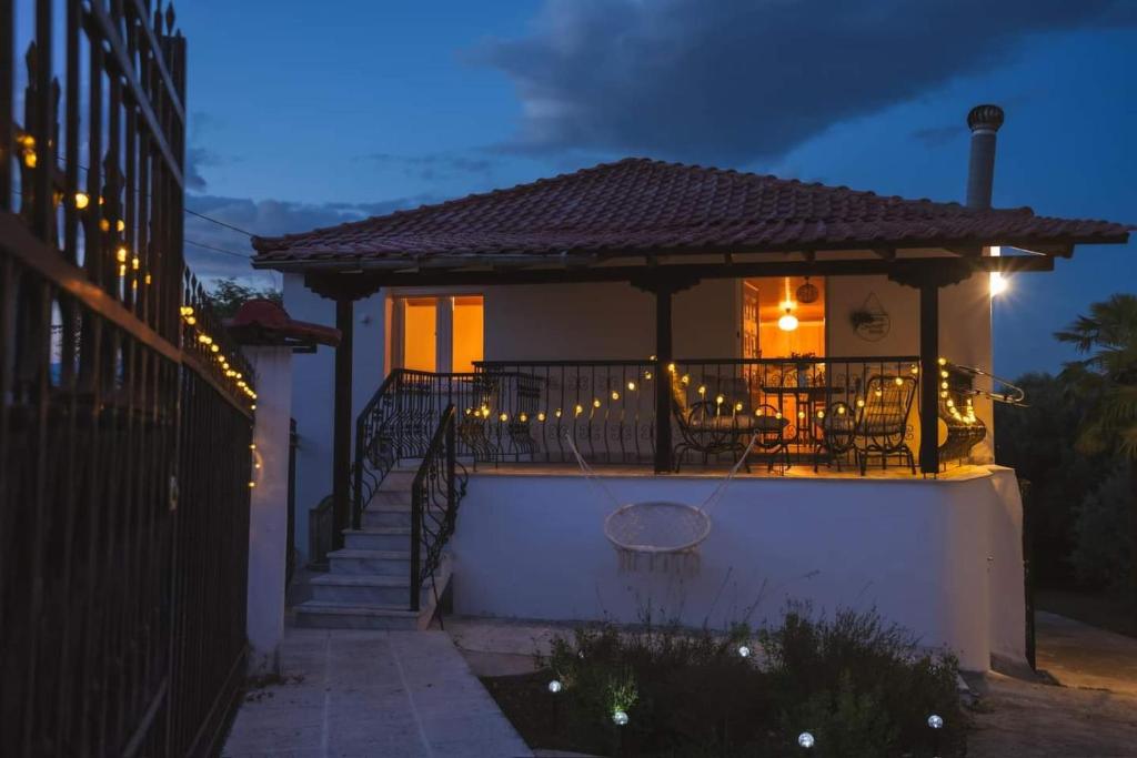 a house with lights on the balcony at night at Gurba's House in Aridaia