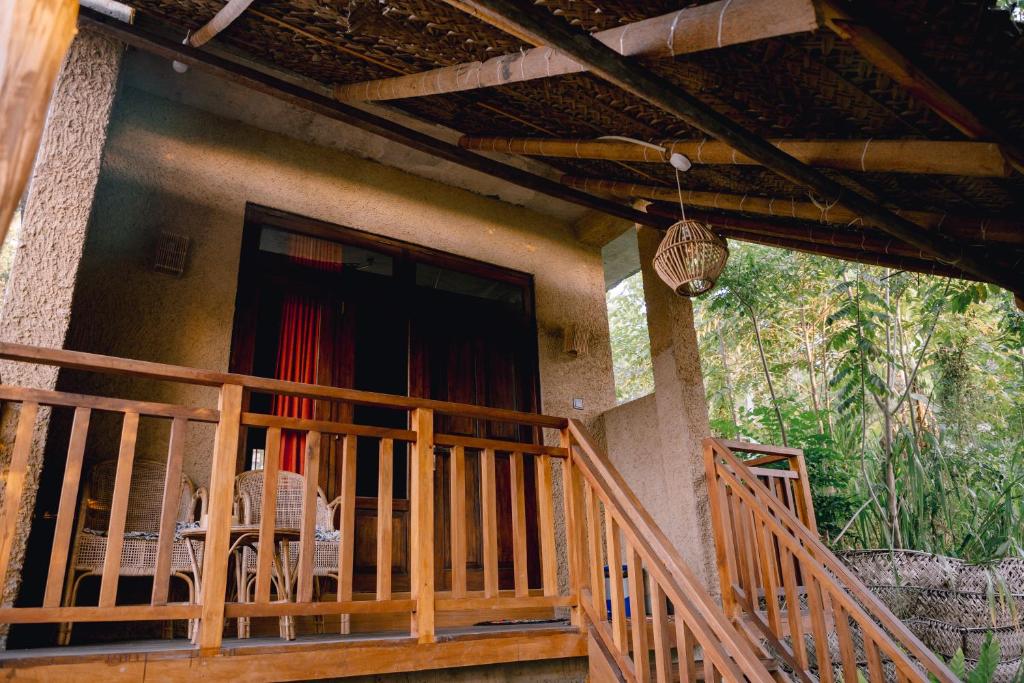 a porch of a house with chairs and a window at Sunset view Beach villa in Tangalle