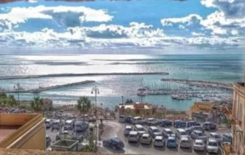 een uitzicht op een strand met auto's geparkeerd op een parkeerplaats bij Da Cristina appartamento in Sciacca