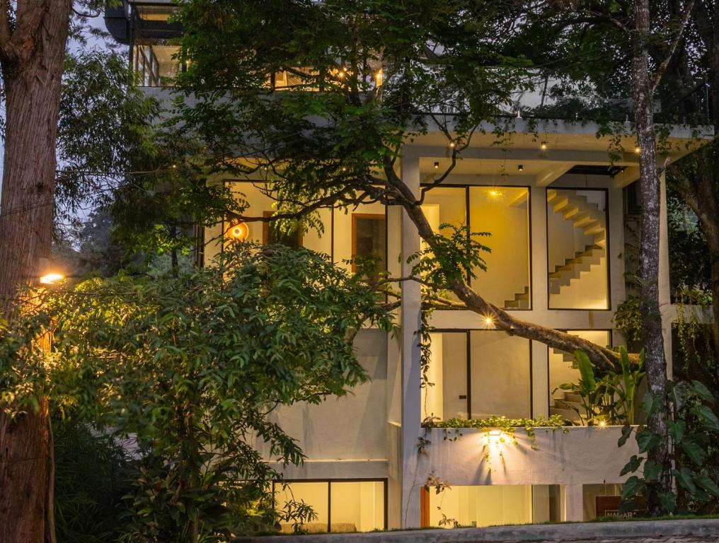 a white building with a lot of windows at Namara Green Ella in Ella