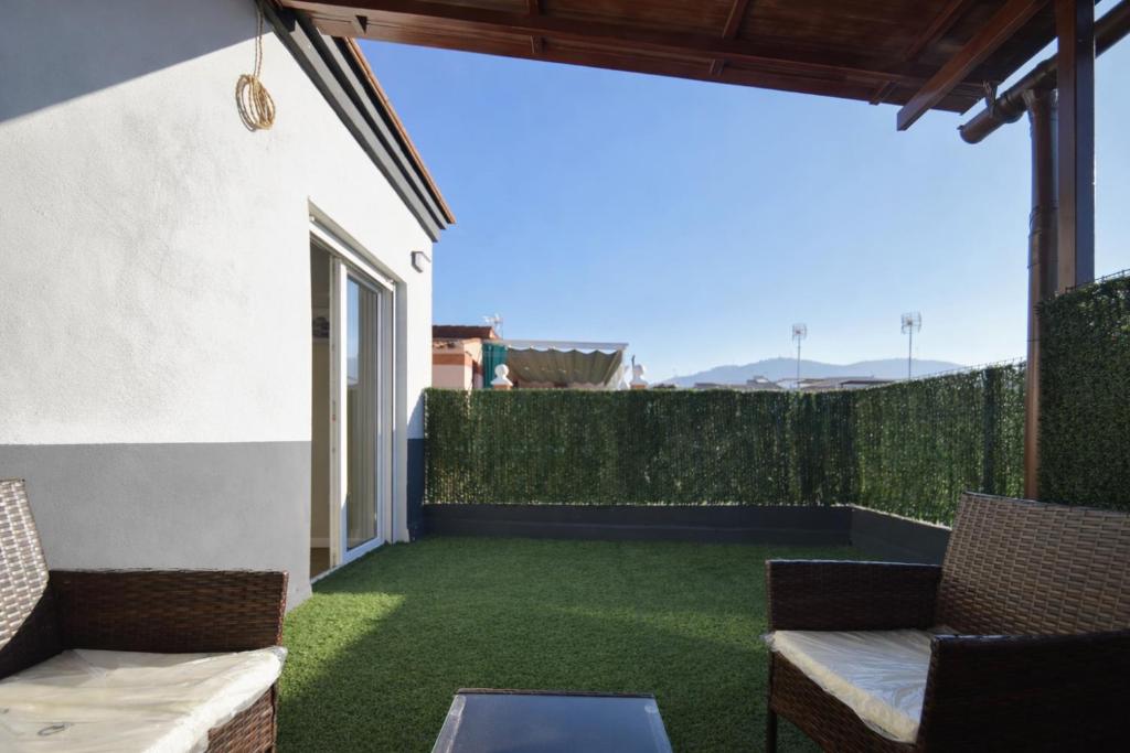 a patio with green grass and chairs on a balcony at San Ambrosio in Granada