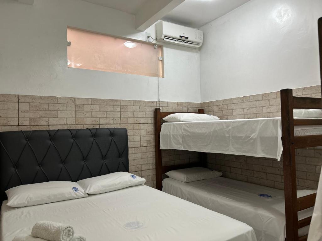 a dorm room with two bunk beds in it at Casas do Matteo - 2ª Praia in Morro de São Paulo