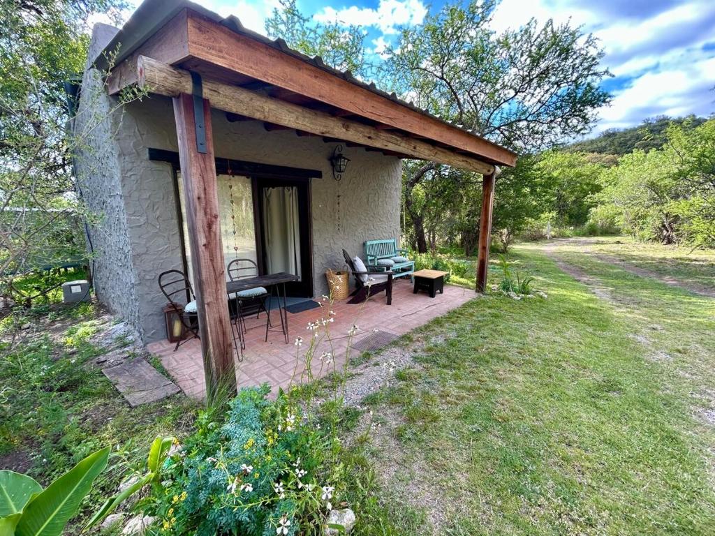 a small house with a porch with a bench at Iris,Tiny house en Las Calles, Traslasierra in Las Calles