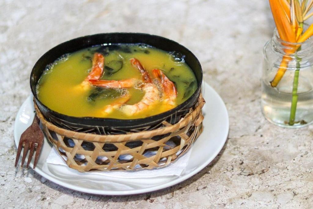 a bowl of soup on a plate on a table at Cantinho Amazônico in Belém