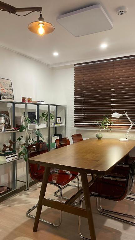a dining room with a wooden table and chairs at 스테이아지트 in Seoul
