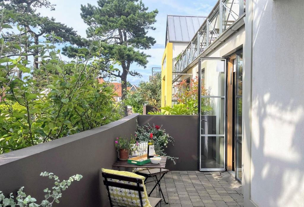 a balcony with two chairs and a table with plants at Regatta - A lakeview apartment in Thorpeness - Aldeburgh Coastal Cottages in Thorpeness