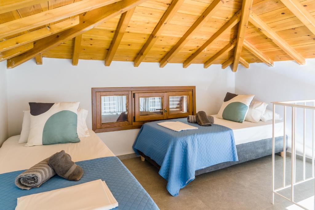 En eller flere senge i et værelse på Péra Skopelos - Péra ex Maistros