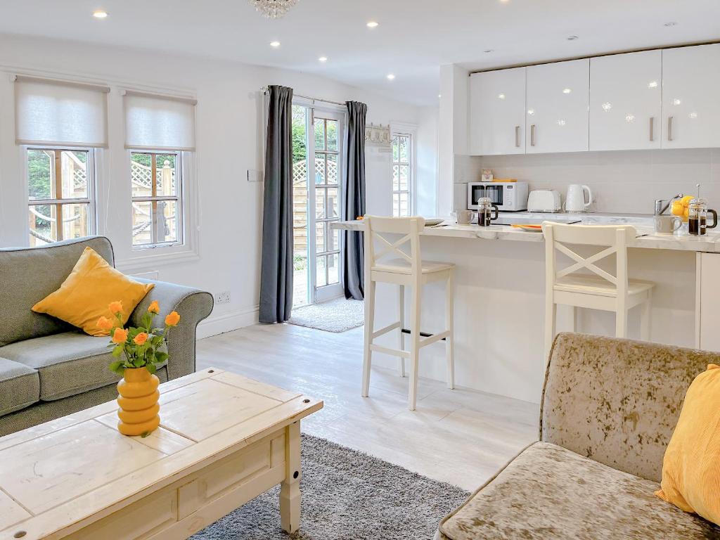 a kitchen and living room with a couch and a table at The Haven Lodge in Clifton
