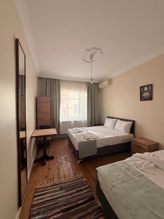 a hotel room with two beds and a desk at walkabout apart in Istanbul