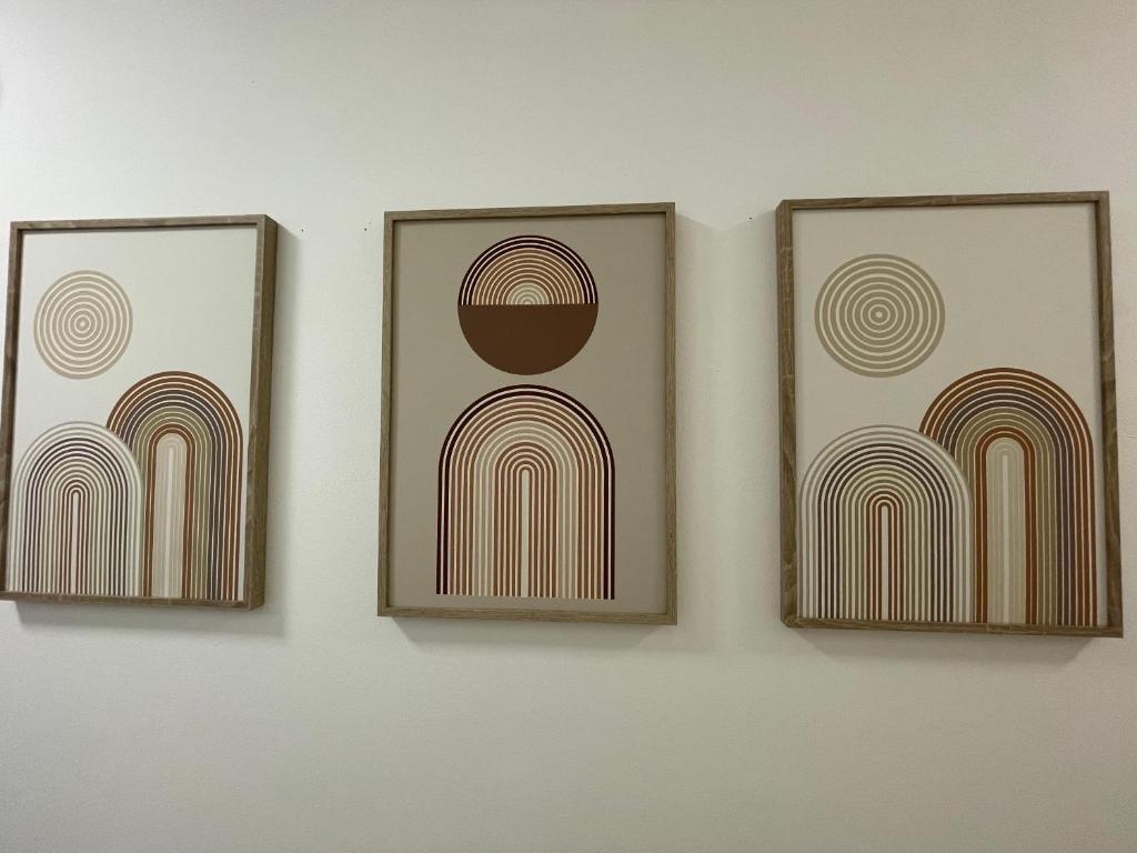 three picture frames on a wall with rainbows at Apartment with a great location in Weilheim in Weilheim in Oberbayern