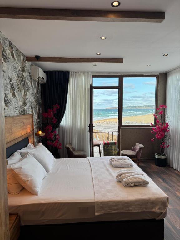 a bedroom with a bed with a view of the ocean at Goga Otel in Sarıyer