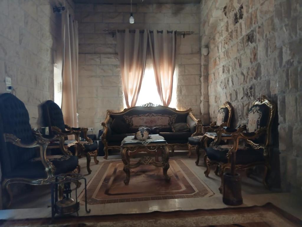 a living room with a couch and chairs and a window at الشاميه سانت كاترين in Saint Catherine