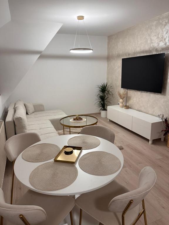 a living room with a white table and chairs at Apartment Kala in Varaždin