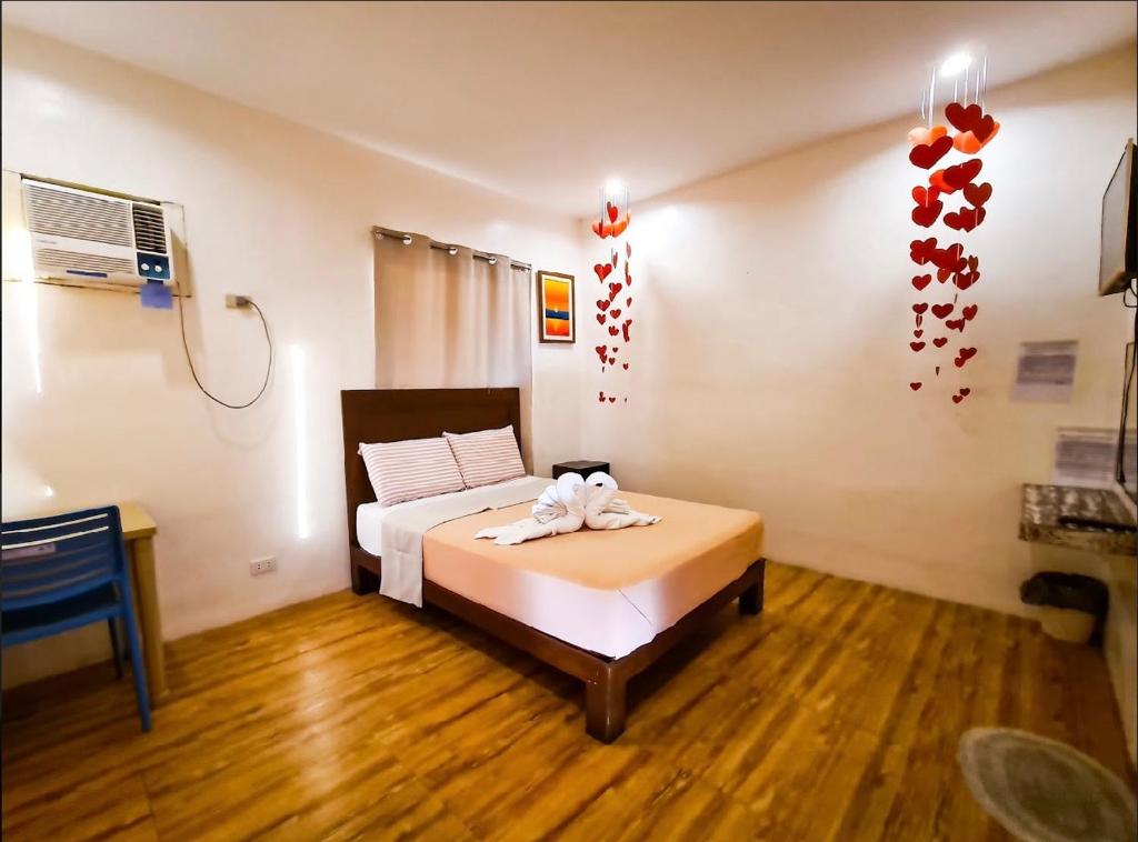 a bedroom with a bed with a towel on it at Baao Las Estrellas in Baao