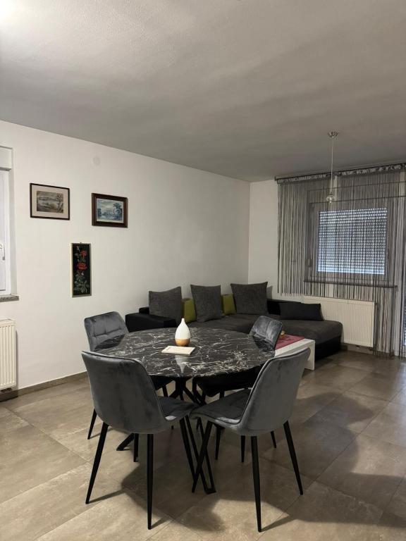a living room with a table and chairs and a couch at Apartman Lapaž 14 in Toplice Sveti Martin