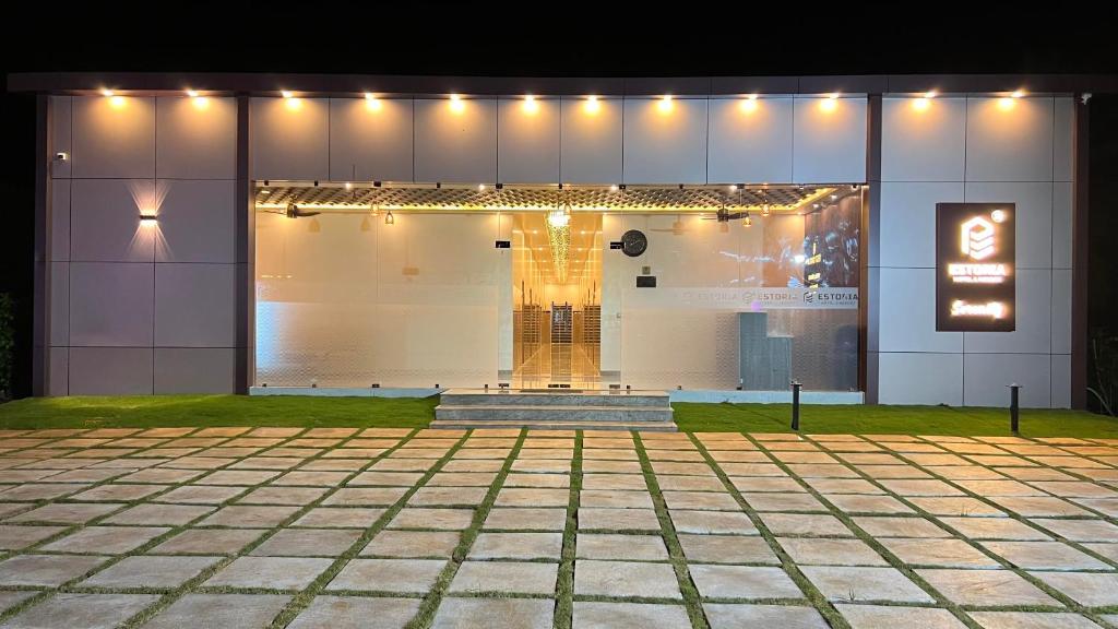 a building with lights on the side of it at Estoria Hotel and Resort in Mysore