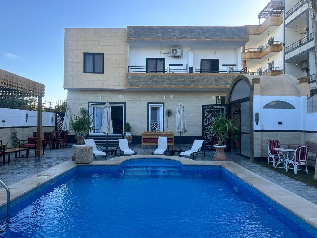 a swimming pool in front of a house at Hamed's House Luxor in Luxor