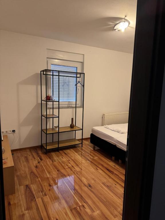 an empty room with a bed and a window at Soba Lapaž in Toplice Sveti Martin